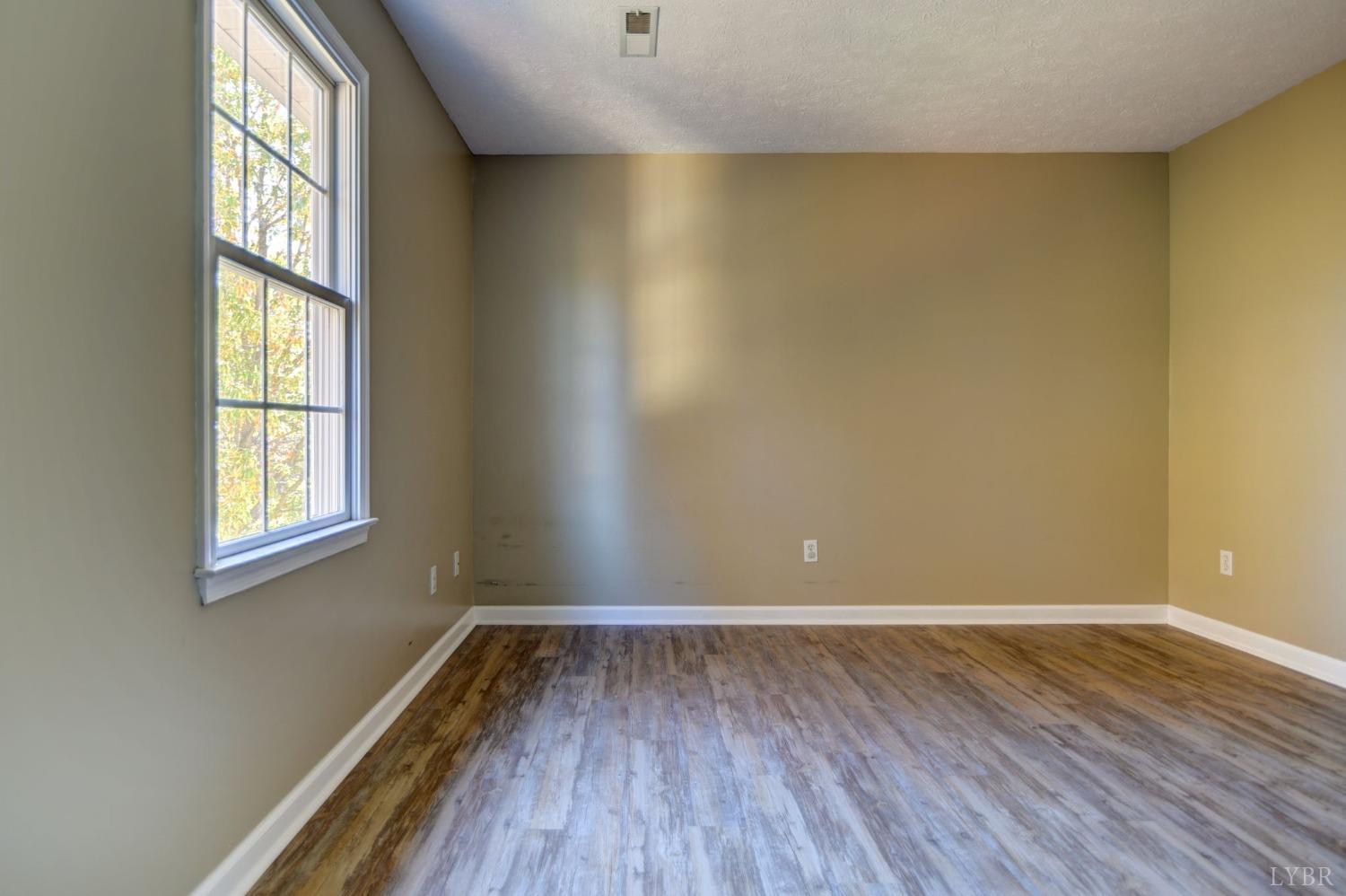 3636 White Road Forest, VA 24551 - Photo 27 of 44 an empty room with wooden floor and windows