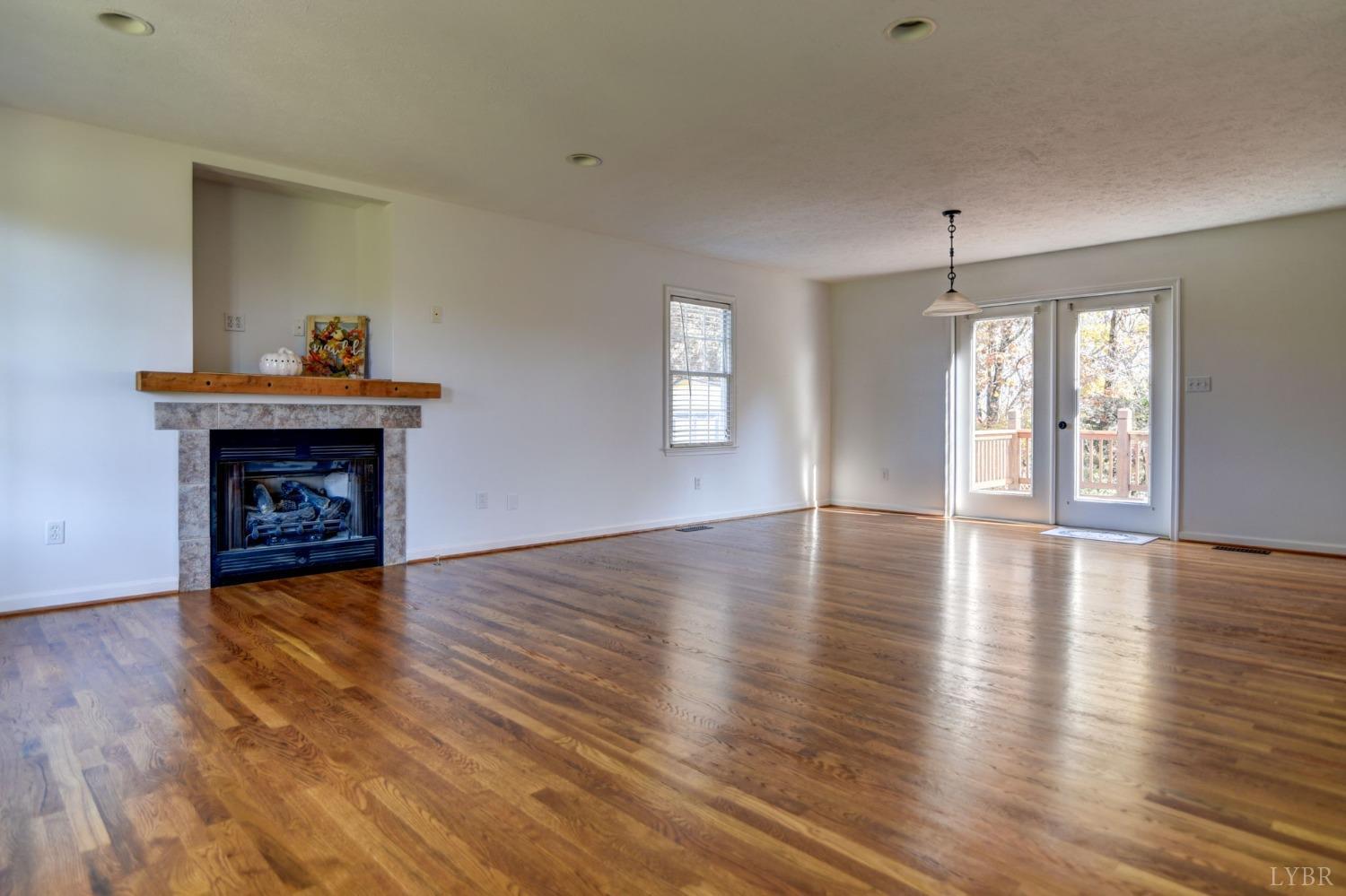 3636 White Road Forest, VA 24551 - Photo 5 of 44 a view of an empty room with wooden floor fireplace and a window