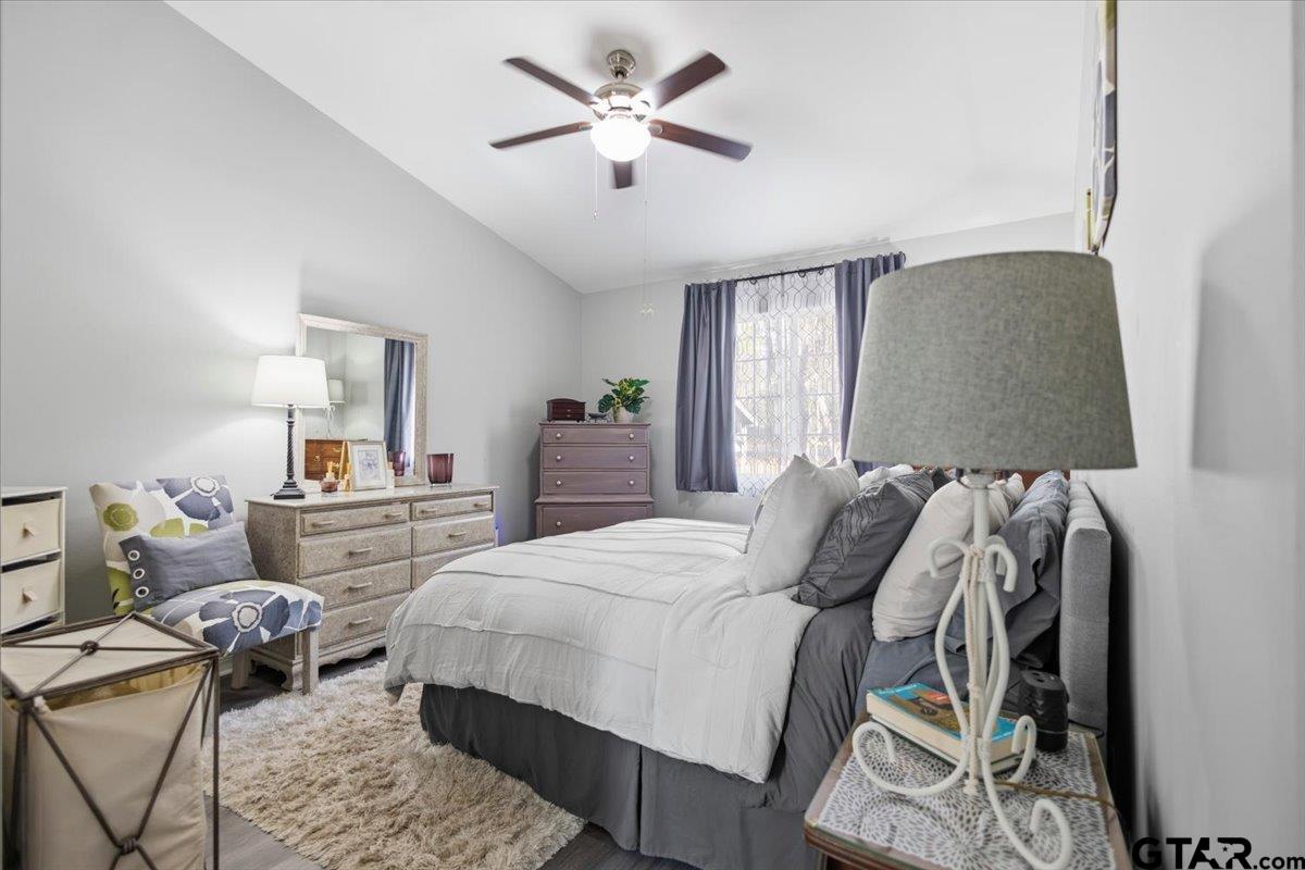 289 Acapulco Road Jefferson, TX 75657 - Photo 13 of 30 a bedroom with a bed and a chandelier