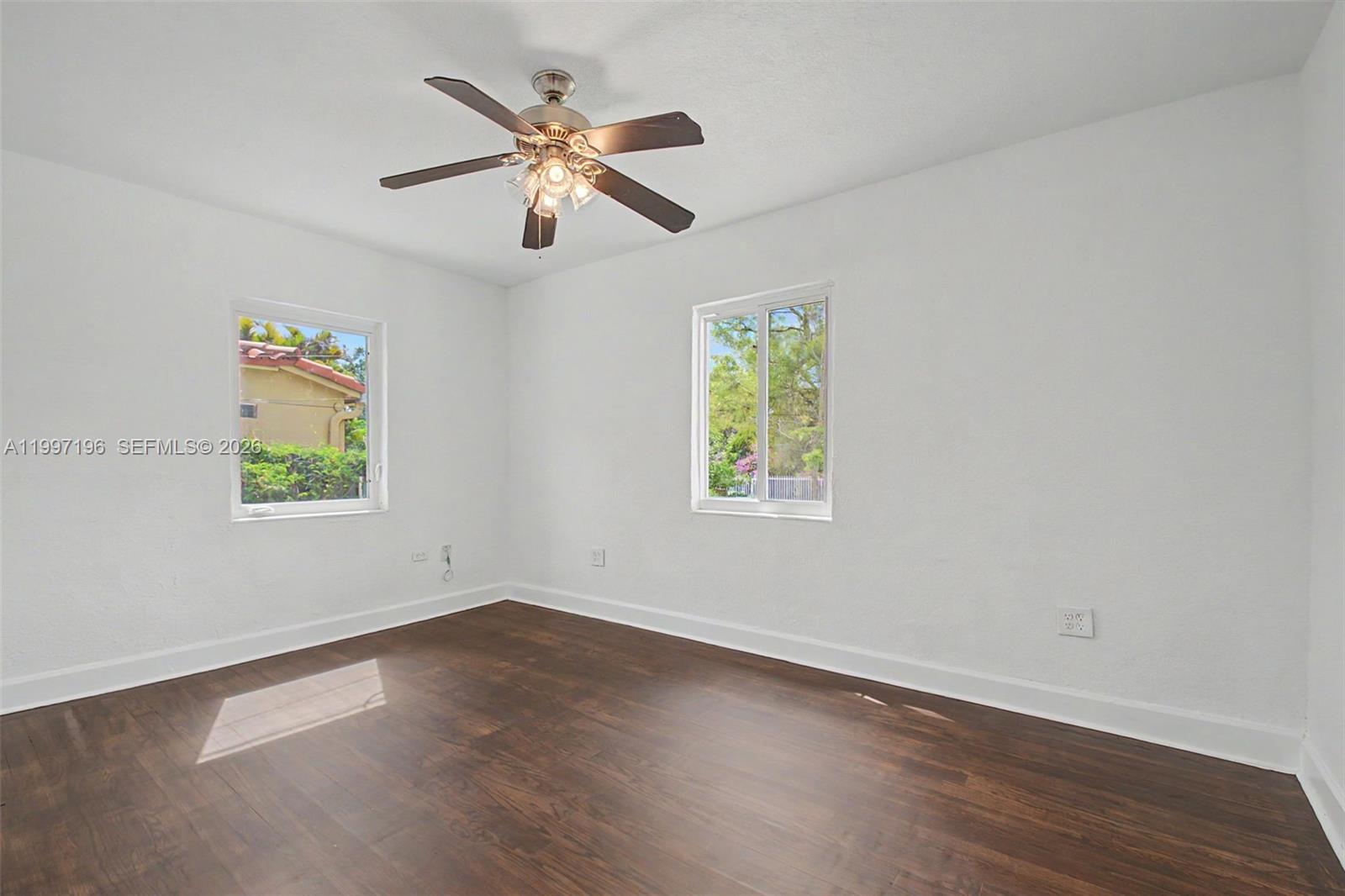 3951 Southwest 2nd Terrace Miami, FL 33134 - Photo 11 of 32 a view of an empty room with wooden floor and a window