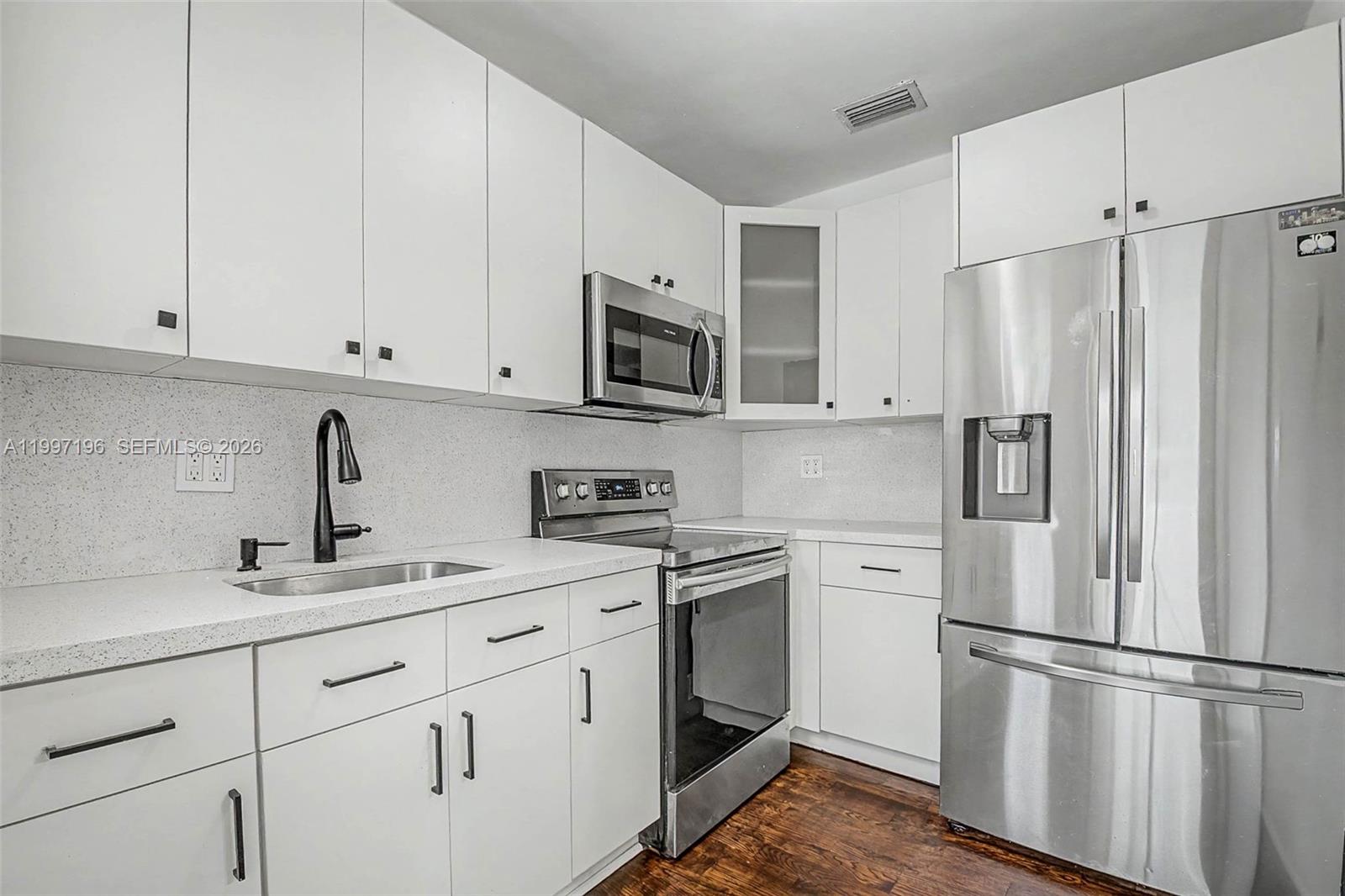 3951 Southwest 2nd Terrace Miami, FL 33134 - Photo 6 of 32 a kitchen with cabinets stainless steel appliances and a sink
