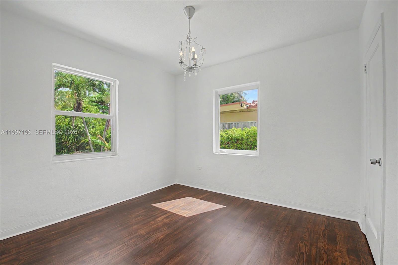 3951 Southwest 2nd Terrace Miami, FL 33134 - Photo 10 of 32 wooden floor in an empty room with a window