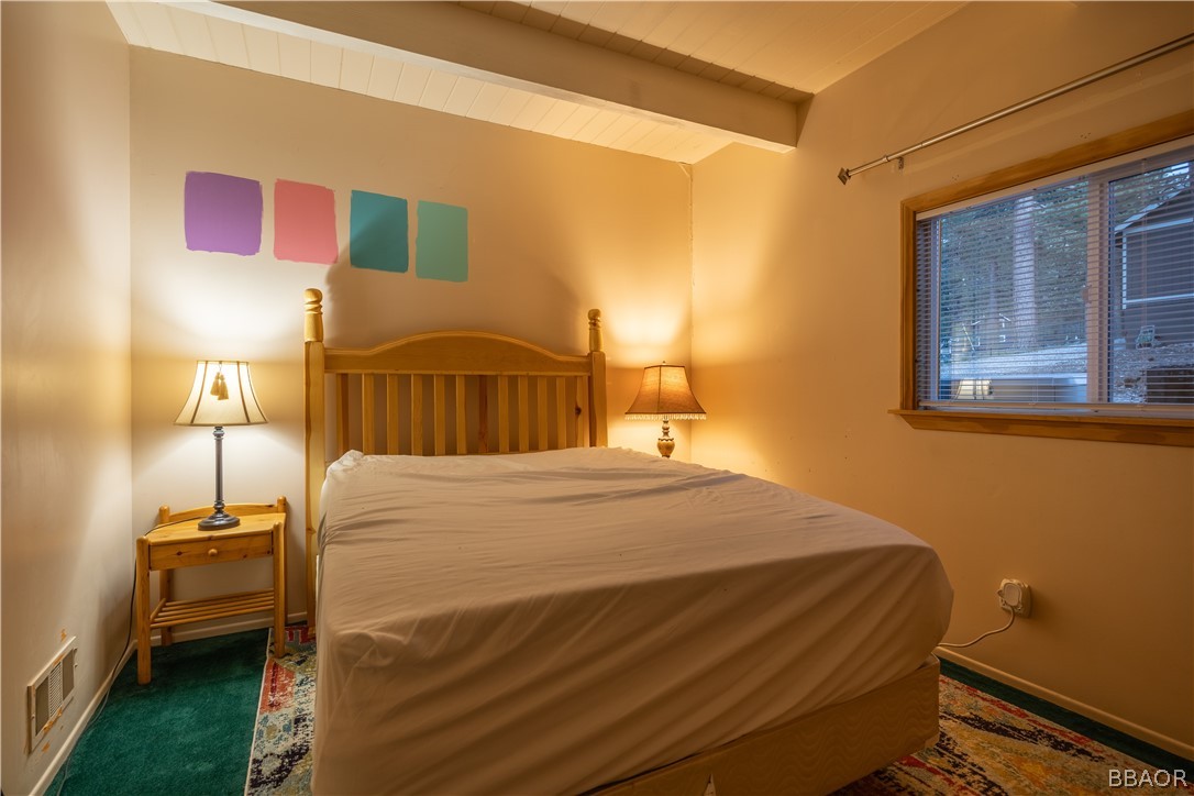 136 Round Drive Big Bear Lake, CA 92315 - Photo 18 of 45 a bedroom with a bed and a night stand