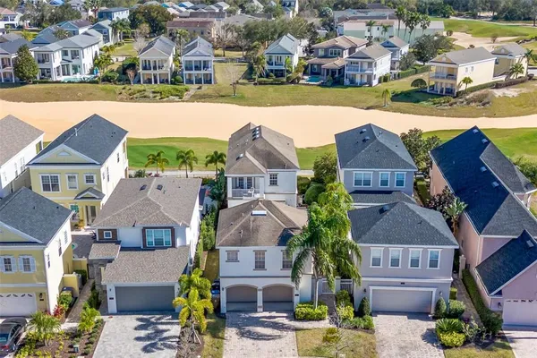 an aerial view of residential houses with outdoor space and parking