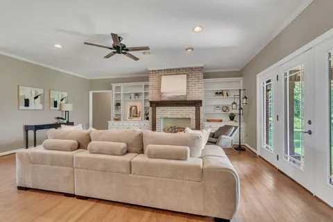a living room with furniture fireplace and a window