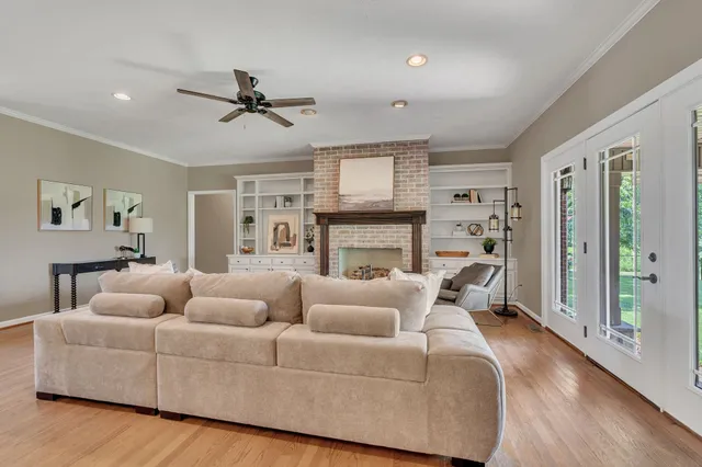 a living room with furniture fireplace and a window