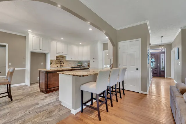 a large kitchen with a table and chairs