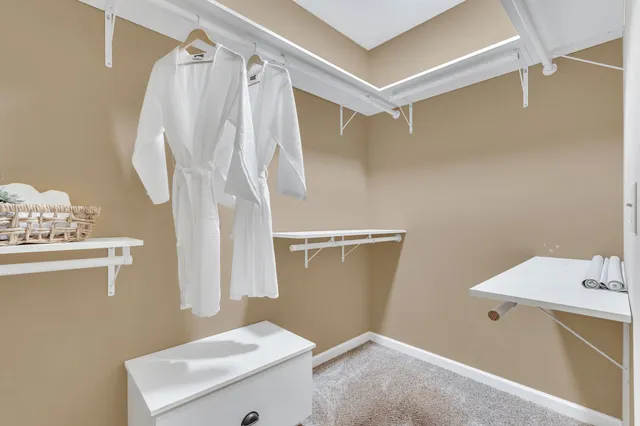 a spacious bathroom with a granite countertop sink a toilet a mirror and vanity