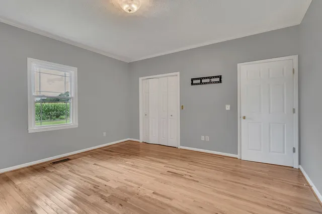 a bathroom with a granite countertop double vanity sink and a mirror