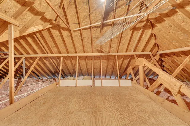 a patio with couches and a dining table with garden view
