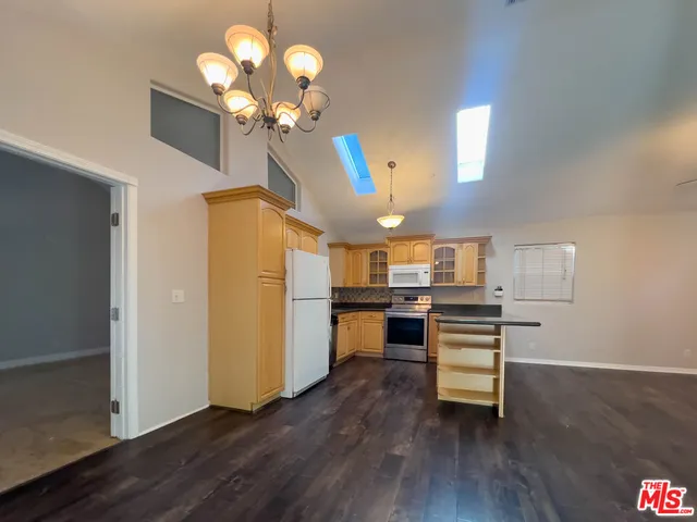 a view of a kitchen with furniture and wooden floor