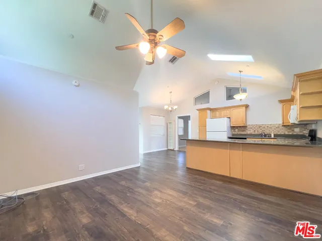 a view of kitchen with sink and wooden floor