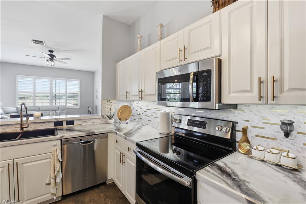 3236 Potomac Court Naples, FL 34120 - Photo 47 of 47 a kitchen with stainless steel appliances a sink stove and microwave