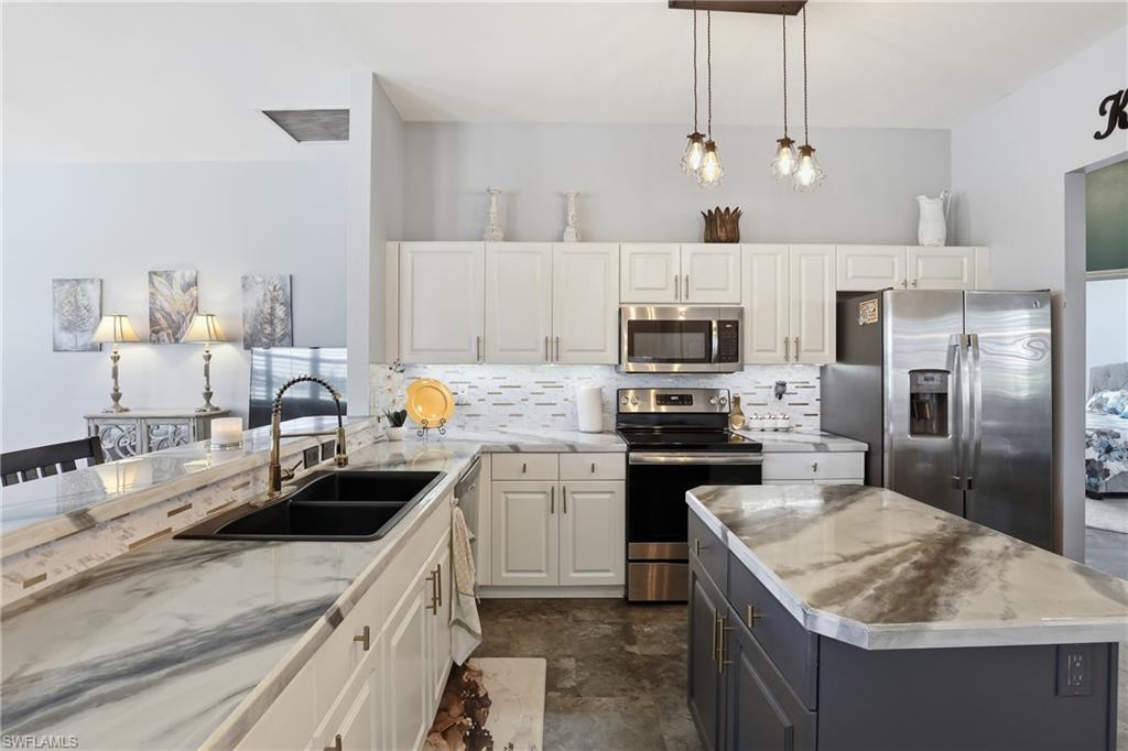 3236 Potomac Court Naples, FL 34120 - Photo 17 of 47 a kitchen with a sink stove and refrigerator