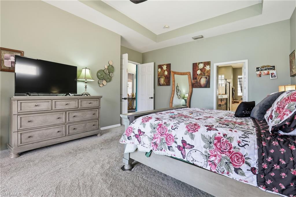 3236 Potomac Court Naples, FL 34120 - Photo 22 of 47 a bedroom with a bed and a flat screen tv in white walls