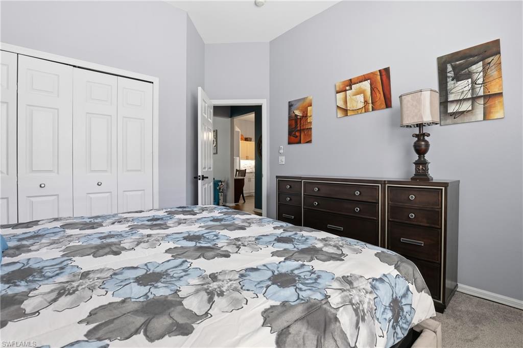 3236 Potomac Court Naples, FL 34120 - Photo 27 of 47 a bedroom with a bed and a cabinet