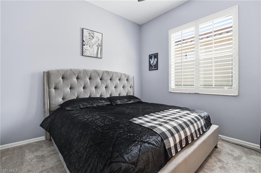 3236 Potomac Court Naples, FL 34120 - Photo 28 of 47 a bed sitting in a bedroom next to a window