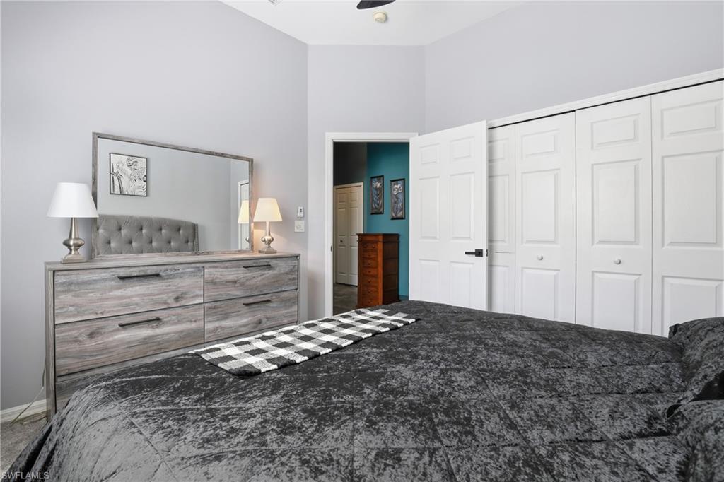 3236 Potomac Court Naples, FL 34120 - Photo 29 of 47 a bedroom with a bed and a painting on the wall