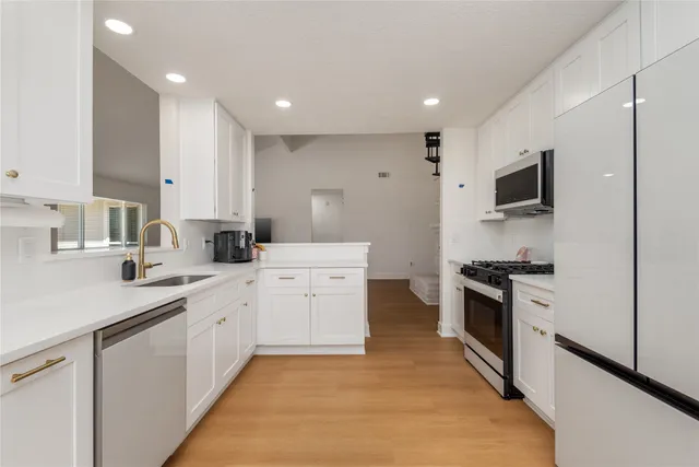 a spacious bedroom with a bed and ceiling fan