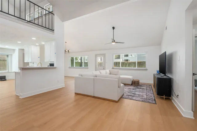 a living room with furniture and a chandelier