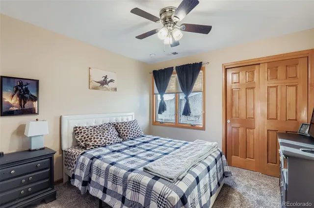 a bedroom with a large bed and a chandelier