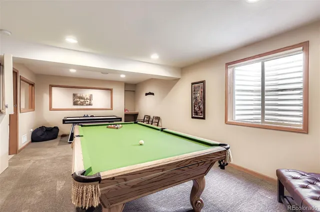 a room with pool tables and windows