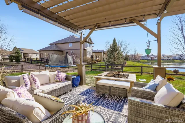 a view of a patio with couches chairs and a fire pit