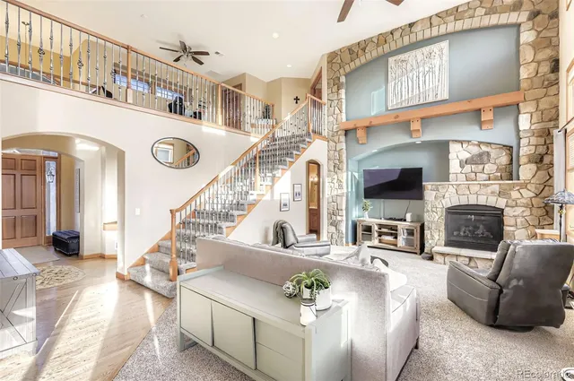 a living room with fireplace furniture and a flat screen tv