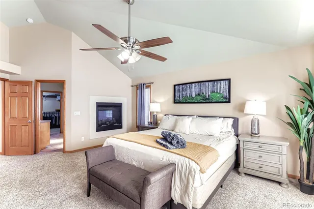 a spacious bedroom with a bed and a chandelier