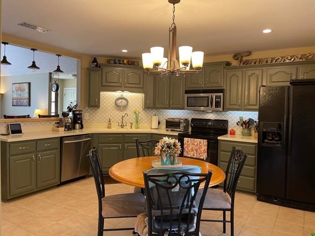 1010 Harmon Drive Atoka, TN 38004 - Photo 4 of 20 a kitchen with a table chairs refrigerator and microwave