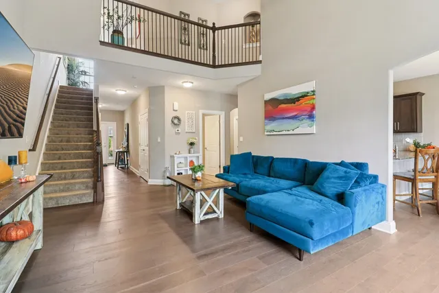 a living room with furniture and stairs