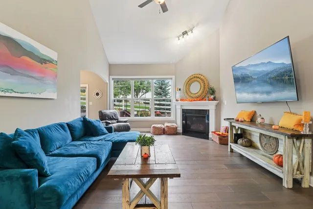 a living room with furniture a fireplace and a flat screen tv