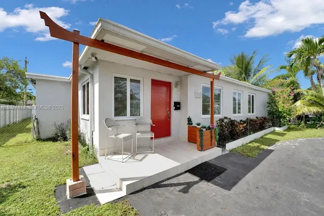 a view of a house with backyard porch and sitting area