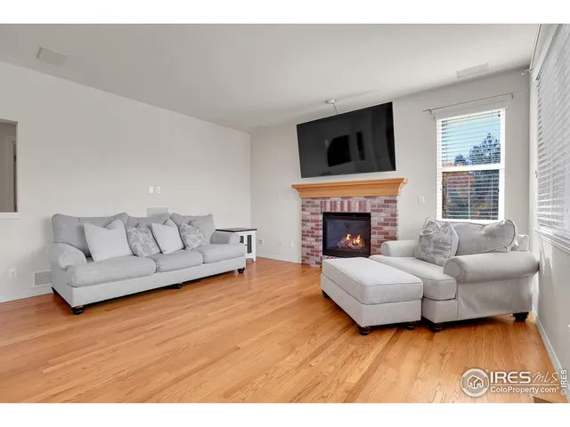 a living room with furniture flat screen tv and a fireplace