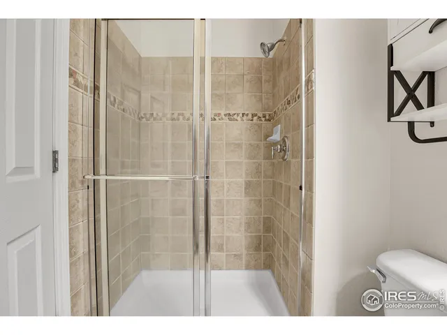 a bathroom with a shower and a toilet