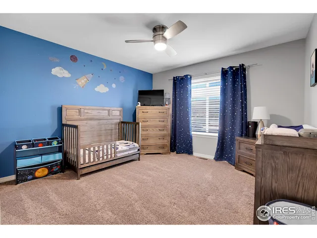 a bedroom with furniture and a flat screen tv