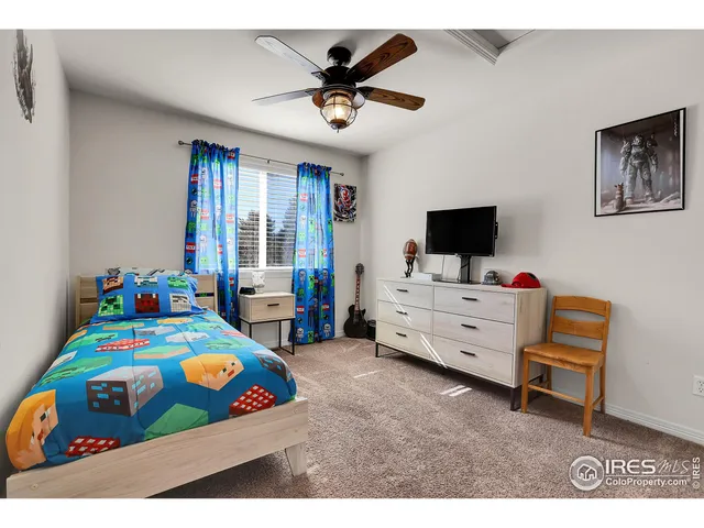 a bedroom with a bed and a tv