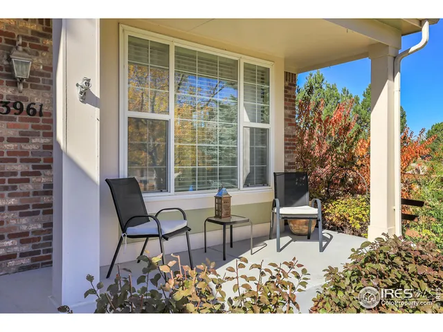 a balcony with chairs and a table