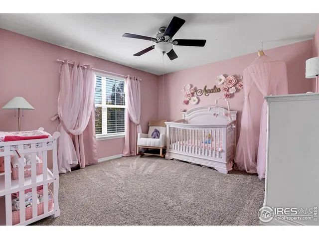 a spacious bedroom with a bed and a window
