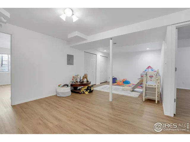 a view of a room with furniture and wooden floor