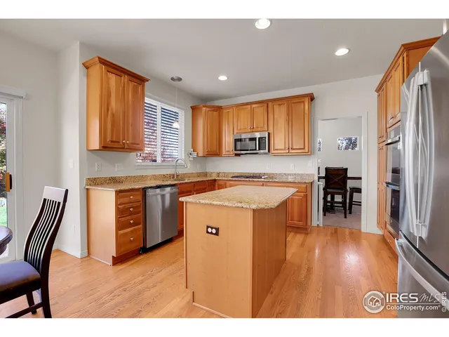 a open kitchen with stainless steel appliances granite countertop a granite counter tops and a refrigerator