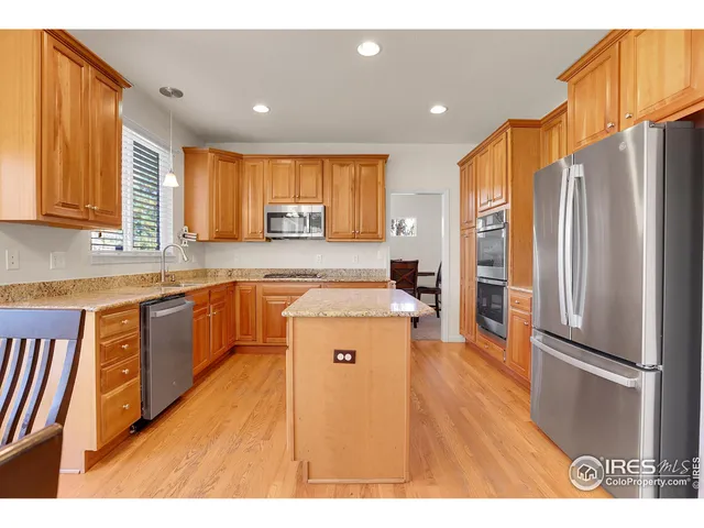 a kitchen with a refrigerator sink and cabinets