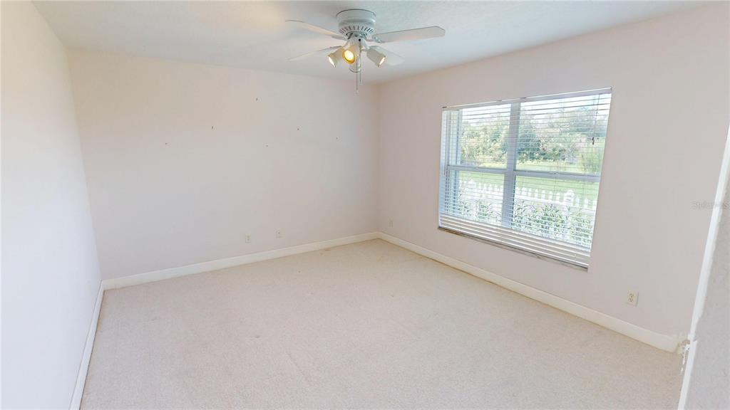 2244 Mauritania Road Punta Gorda, FL 33983 - Photo 22 of 46 an empty room with a window and a fan