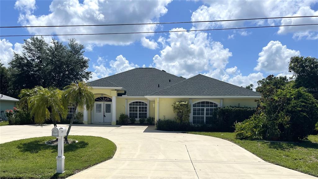2244 Mauritania Road Punta Gorda, FL 33983 - Photo 37 of 46 a front view of a house with a yard and garage
