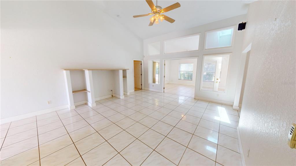 2244 Mauritania Road Punta Gorda, FL 33983 - Photo 6 of 46 a view of a hallway with closet and a chandelier fan