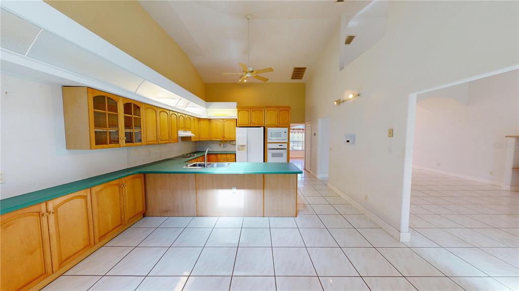 2244 Mauritania Road Punta Gorda, FL 33983 - Photo 9 of 46 a kitchen with stainless steel appliances a stove a sink and a refrigerator