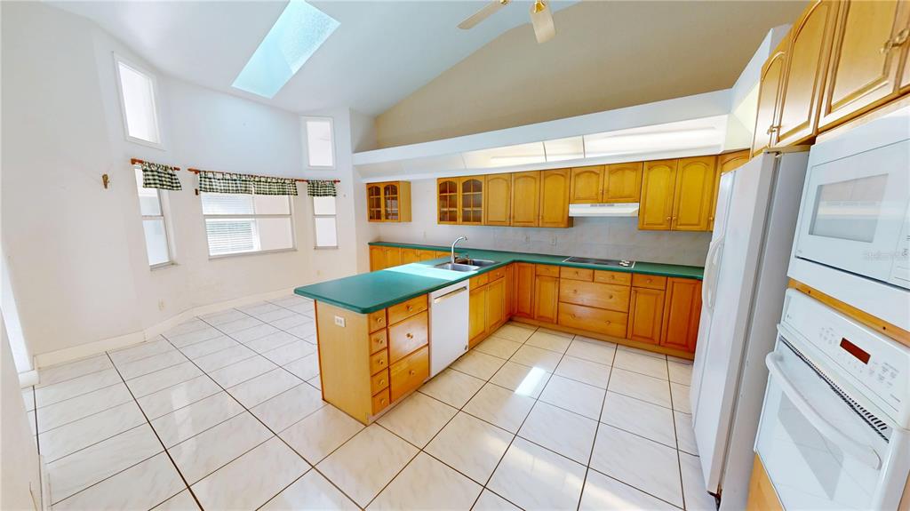 2244 Mauritania Road Punta Gorda, FL 33983 - Photo 10 of 46 a kitchen with stainless steel appliances granite countertop a sink and cabinets