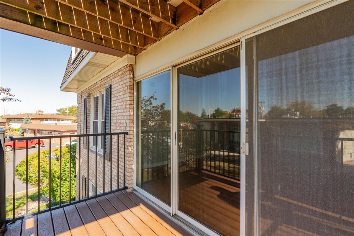 111 Rust Road, Unit 211 Bloomington, IL 61701 - Photo 15 of 15 a view of balcony with floor to ceiling window wooden floor