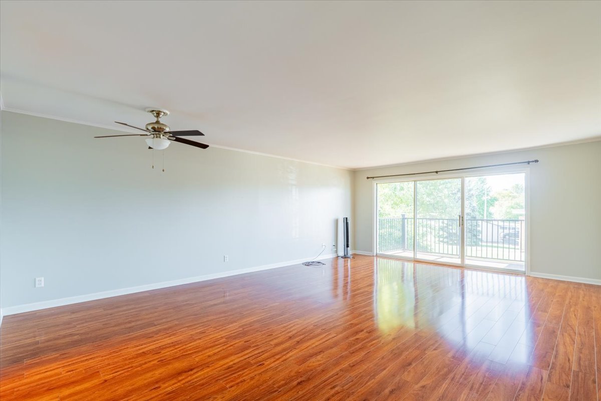 111 Rust Road, Unit 211 Bloomington, IL 61701 - Photo 5 of 15 a view of an empty room with wooden floor and a window