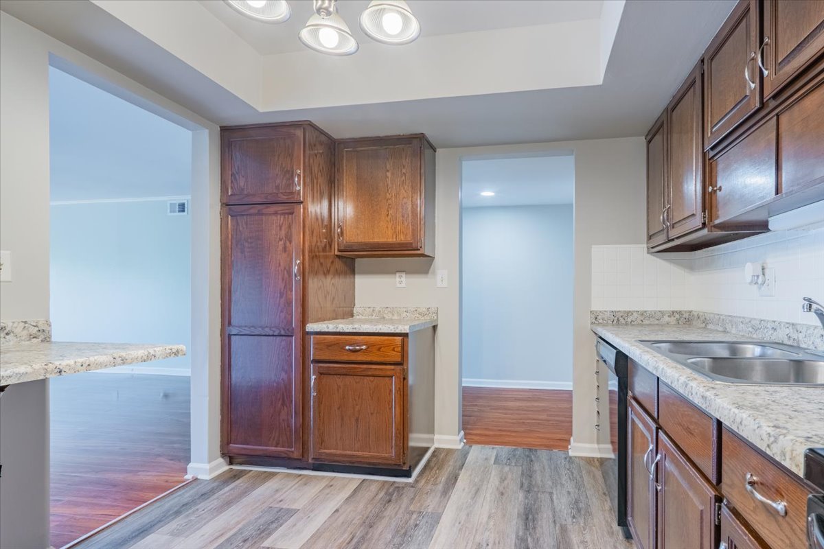 111 Rust Road, Unit 211 Bloomington, IL 61701 - Photo 8 of 15 a kitchen with kitchen island granite countertop wooden cabinets and a sink